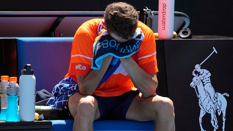 Terence Atmane of France reacts as he sits in his chair after retiring from his first round match against Daniil Medvedev of Russia at the Australian Open tennis championships at Melbourne Park, Melbourne, Australia, Monday, Jan. 15, 2024. (AP Photo/Andy Wong)