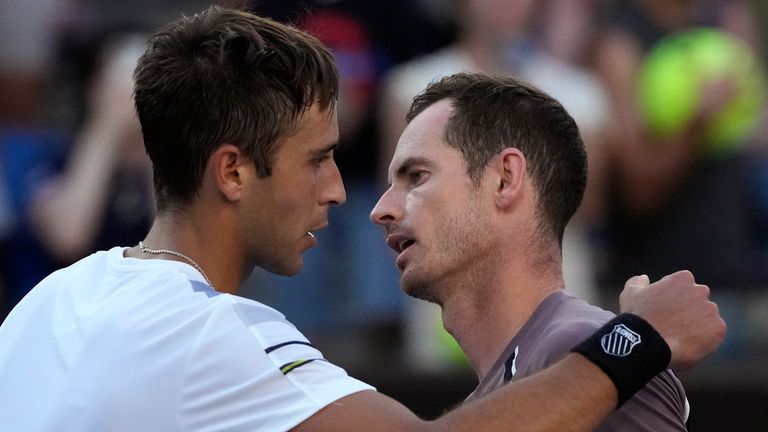 Tomas Martin Etcheverry, left, of Argentina, is congratulated by Andy Murray of Britain following their first round match at the Australian Open tennis championships at Melbourne Park, Melbourne, Australia, Monday, Jan. 15, 2024. (AP Photo/Andy Wong)